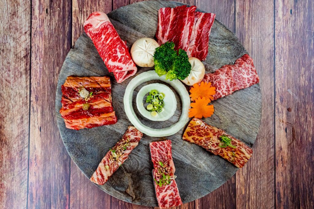 pexels-photo-19998391 Aesthetic top view of a colorful meat and vegetable platter arranged on a wooden tray.