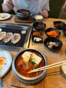 Authentic Korean meal featuring kimchi stew and BBQ pork with side dishes.